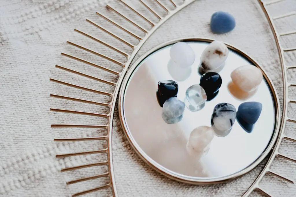 types of crystals resting on a mirror