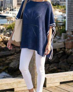 truboo yarn in navy crocheted into a summer poncho styled on a model in a summer coastal town
