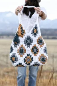 granny square bag being held by a woman
