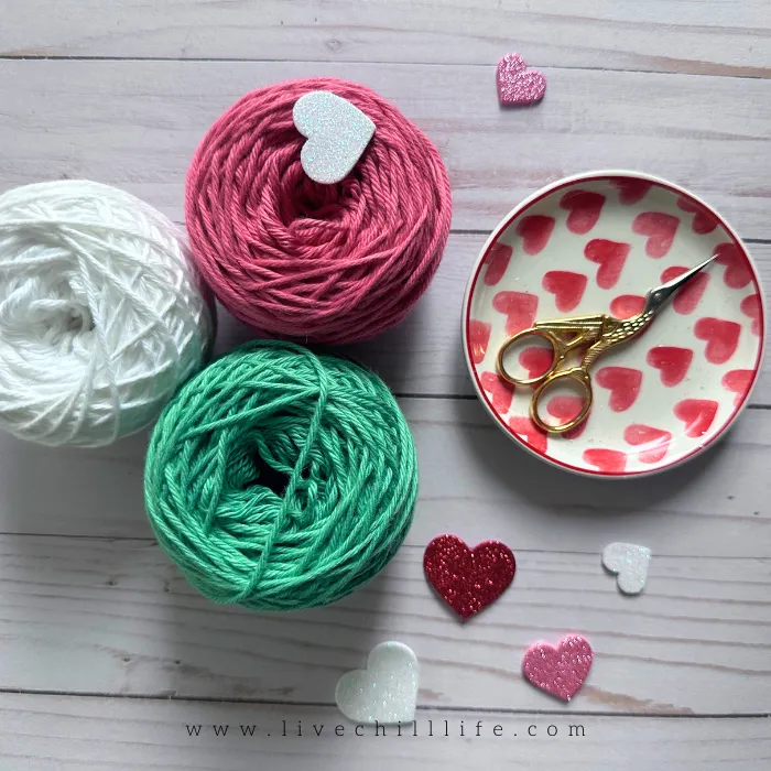 white, pink and green yarn balls