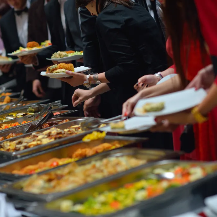 party guests at a buffet display filling their plates