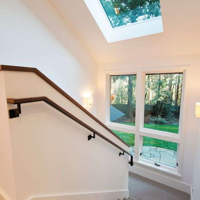 Home stairway with skylight and windows