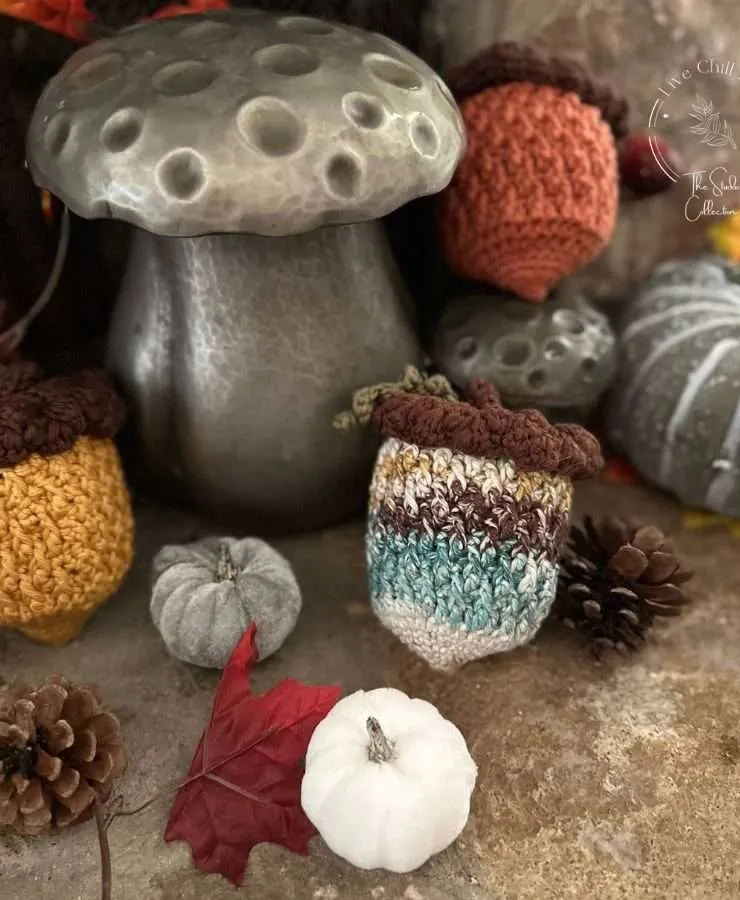 crochet acorn display on stone with fall accents