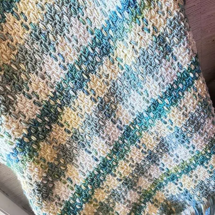 crochet plaid blanket in shades of yellow, teal and gold