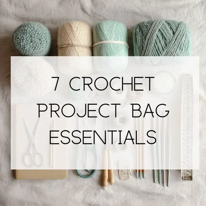 crochet project items including, skeins of rolled yarn, small scissors, a project tracker and crochet hooks
