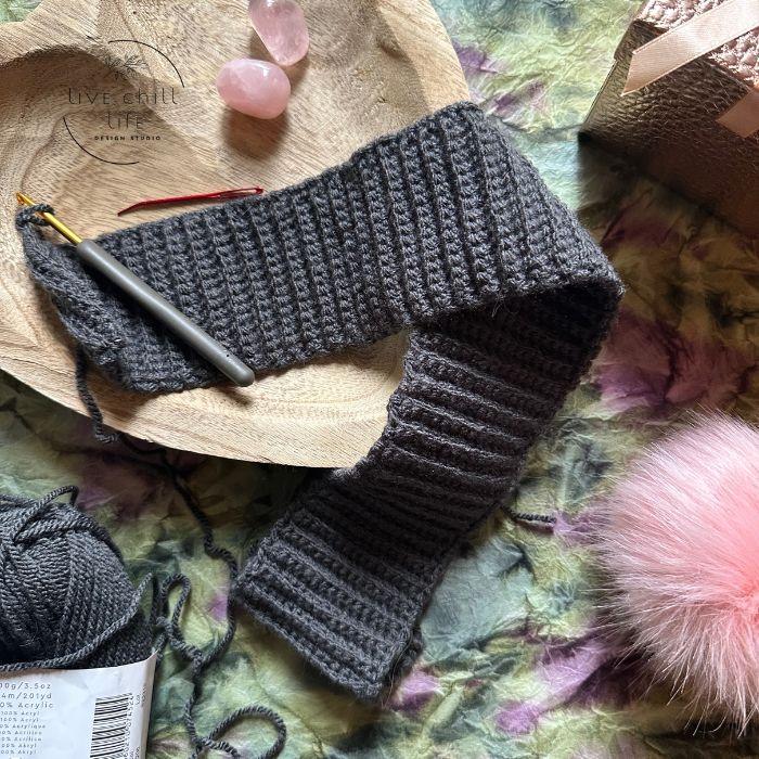 crochet hat brim in progress made with deep gray yarn