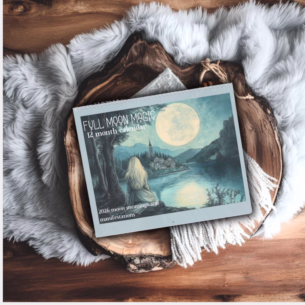 Full moon manifestation calendar on a wood tray with soft blanket